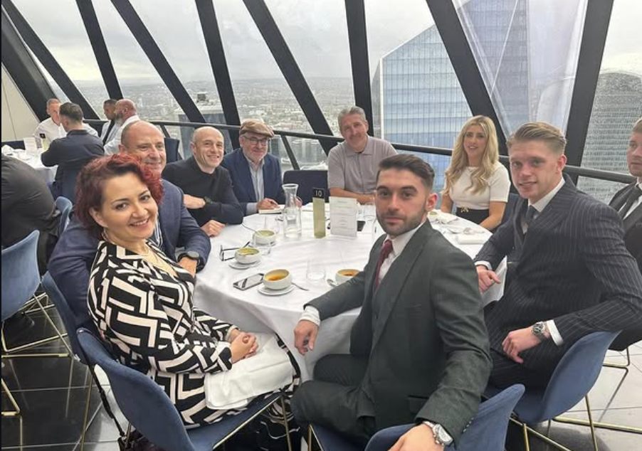 Tom at dinner with Alfie Best Sr. and guests above the City of London